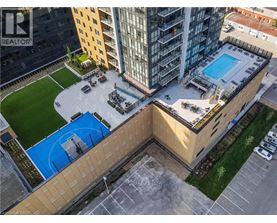 A swimming pool is located on the roof of a building.