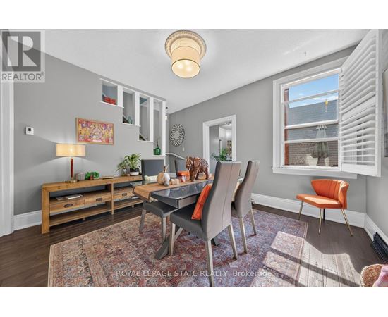 A well-lit dining room with a table set for four.