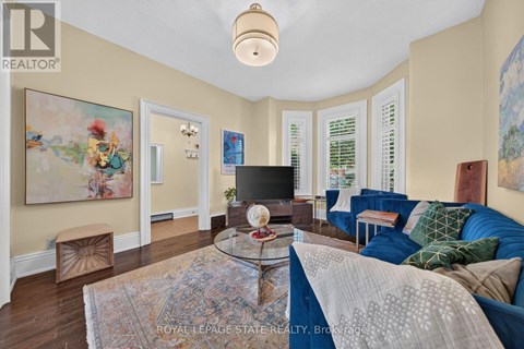 A living room with a blue couch and a glass coffee table.
