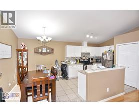 A kitchen with a dining table and chairs.