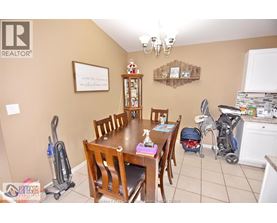A dining room with a wooden table and chairs.