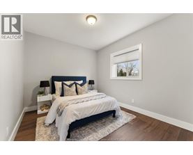 A bedroom with a large bed and a window.