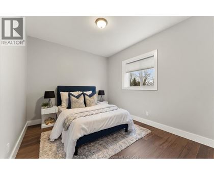A bedroom with a large bed and a window.