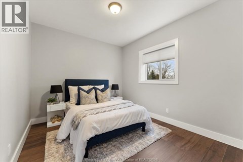 A bedroom with a large bed and a window.