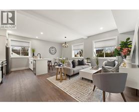 A well-lit, modern living room with a grey sofa and a wooden coffee table.