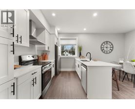 A modern kitchen with white cabinets and a large island.