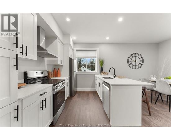 A modern kitchen with white cabinets and a large island.
