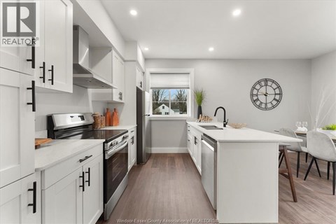 A modern kitchen with white cabinets and a large island.