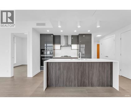 A modern kitchen with a large island in the middle.