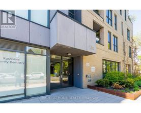 The front of a building with a glass door and windows.