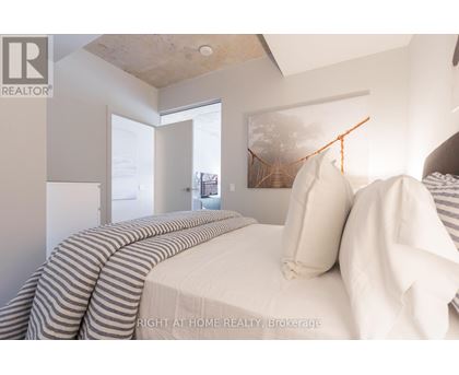 A bedroom with a bed and a window.