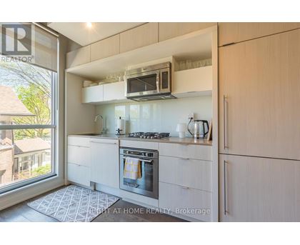 A modern kitchen with a stove top oven and a microwave above it.