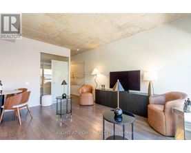 A living room with a wooden floor and furniture.