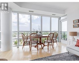 A dining room with a table and chairs with a view of the outdoors.