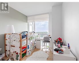 A bedroom with a bunk bed and a desk with a chair.