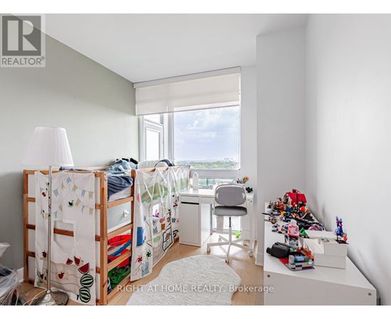 A bedroom with a bunk bed and a desk with a chair.