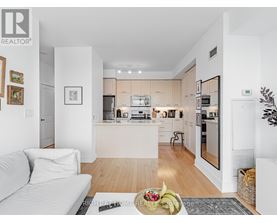 A modern kitchen with white cabinets and appliances.