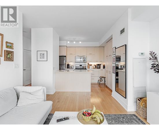 A modern kitchen with white cabinets and appliances.