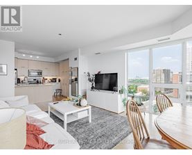 A modern living room with a flat screen TV and a view of the city.