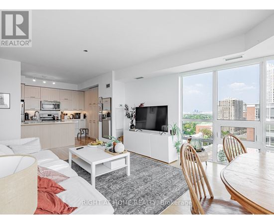 A modern living room with a flat screen TV and a view of the city.