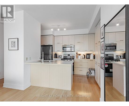 A modern kitchen with white cabinets and appliances.