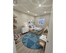 A bedroom with a bed, dresser, and a window.