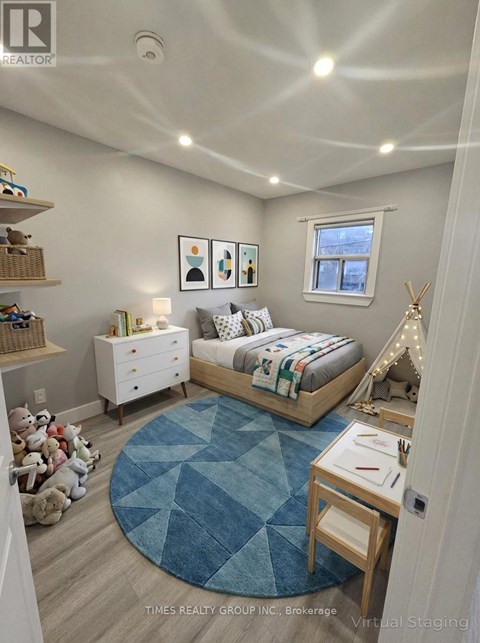 A bedroom with a bed, dresser, and a window.