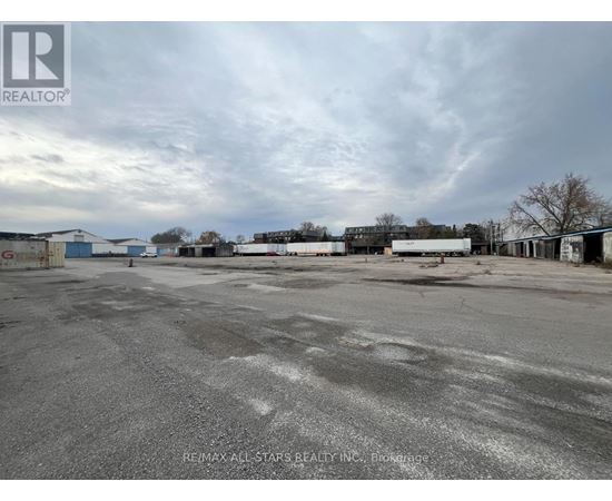 A large, empty parking lot with a cloudy sky overhead.