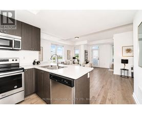 A modern kitchen with dark wood cabinets and stainless steel appliances.
