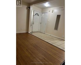 A room with a white door and a mirror on the wall.