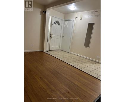 A room with a white door and a mirror on the wall.