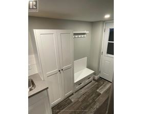 A white kitchen with a sink and cupboards.