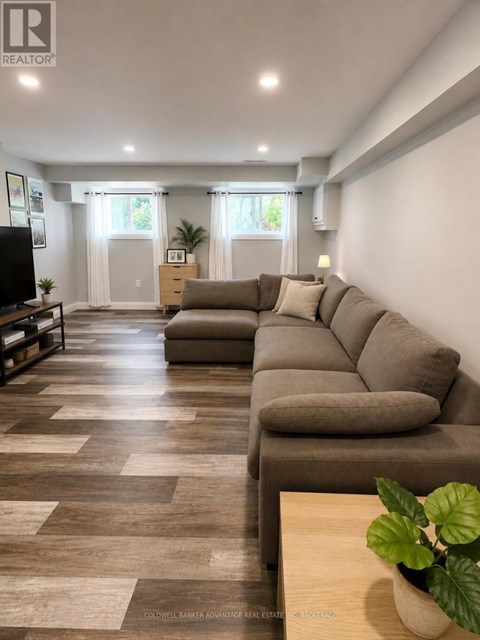 A living room with a long couch and a television.