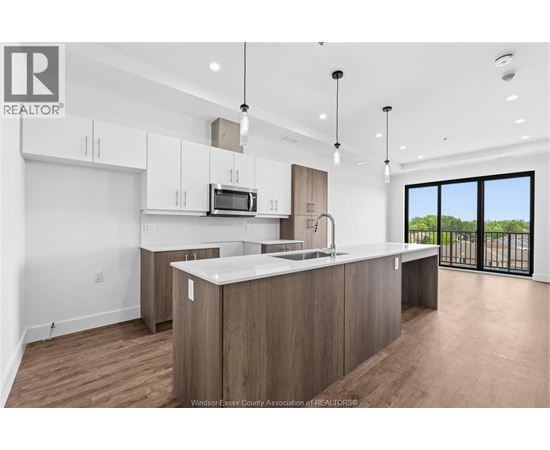 A modern kitchen with wooden cabinets and a large island.