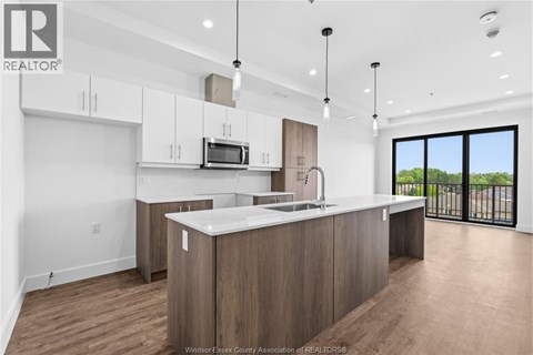 A modern kitchen with wooden cabinets and a large island.
