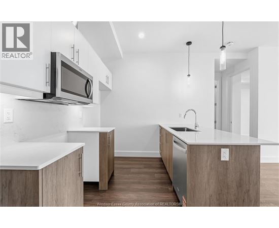 A modern kitchen with wooden cabinets and a white countertop.