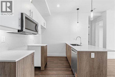 A modern kitchen with wooden cabinets and a white countertop.