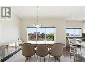 A modern dining room with a table set for four.