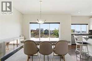 A modern dining room with a table set for four.