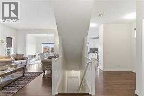 A real estate sign is on the wall of a spacious, well-lit room.