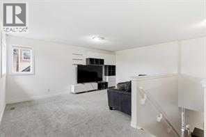 A living room with a television and a couch.