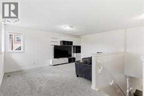 A living room with a television and a couch.