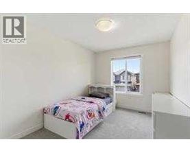 A bedroom with a bed and a window.