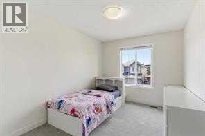 A bedroom with a bed and a window.