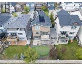 A bird's eye view of a residential area with houses and green lawns.