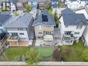 A bird's eye view of a residential area with houses and green lawns.