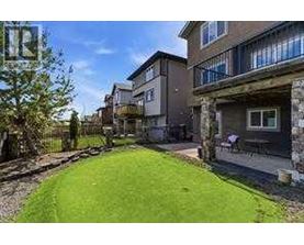 A grassy area in front of apartment buildings.