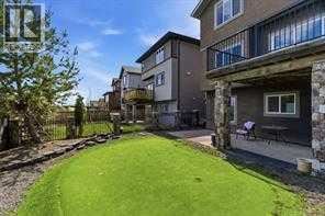 A grassy area in front of apartment buildings.