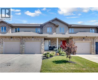 A large house with a red door is for sale.