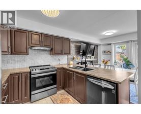 A kitchen with brown cabinets and a black stove top oven.